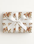 Gift box wrapped in a vintage baby paper featuring cowboy baby boys and gentle farm bulls on a ivory background.