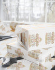 White wrapping paper with a repeating pastel carousel print, shown wrapped around gift boxes on a table near scissors and a ribbon, with a softly blurred window background.