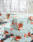 Light blue Christmas airplane wrapping paper featuring Santa Claus as a pilot, shown wrapped around gift boxes on a table near a window.