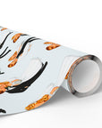 A roll of wrapping paper with a mid-century illustration and a repeating pattern of a kitschy 1950s bride and groom on a blue background.
