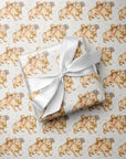 Gift wrapped in paper with calf and baby pattern and wrapped in a white ribbon.