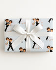 Gift wrapped in vintage-style first dance wedding wrapping paper with a dancing bride and groom on pale blue, tied with a white satin bow
