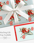 Vintage-style flying Santa airplane Christmas card with matching peppermint Santa Express gift wrap, tied with white satin ribbon