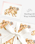 Little cowgirl baby girl greeting card shown with matching vintage-inspired cowgirl gift wrap tied with a white satin bow
