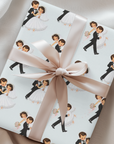 Gift wrapped in vintage-style bride and groom wedding wrapping paper on pale blue, tied with a blush satin ribbon and bow on soft fabric