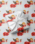 Gift wrapped in vintage-style patriotic angel Christmas wrapping paper with trumpet angels, tiny American flags and a white satin bow