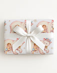 Small gift wrapped in polar bear hug baby boy gift wrap with a white bow, winter baby shower gift