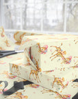 Wrapped presents in retro safari giraffe wrapping paper on a gift wrapping table with scissors and ribbon by a sunny window
