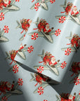 Light blue wrapping paper with a repeating pattern of Santa Claus in a silver Santa Express airplane, surrounded by red and white peppermint candies.