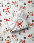 Gift wrapped in vintage-style Christmas wrapping paper with Santa and snowmen playing tennis and a white satin bow, Santa tennis gift wrap