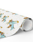 A roll of wrapping paper featuring a repeating pattern of airplanes in blue with gold accents on an ivory background.