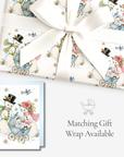 Vintage-style snowman baby boy Christmas card with matching blue baby carriage snowman gift wrap, tied with white satin ribbon