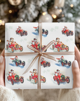 Hands holding a Christmas gift wrapped in vintage-style snowman race car wrapping paper with a copper striped ribbon bow