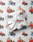 Gift wrapped in vintage-style Christmas wrapping paper with snowmen driving red vintage race cars, snowman race car gift wrap