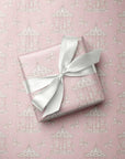 Close-up of vintage carousel gift wrap paper highlighting the fine white line-art pattern of carousel horses and whimsical merry-go-round poles.