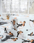 Stacked wedding gifts wrapped in vintage-style first dance bride and groom wrapping paper on a wrapping table with scissors and sheer ribbon