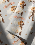 Vintage cowboy groom and cowgirl bride on gray wedding wrapping paper with pink Just Hitched banners and golden horseshoes.