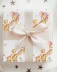 Wild one first birthday gift wrapped in safari giraffe wrapping paper with a cream ribbon bow and scattered stars