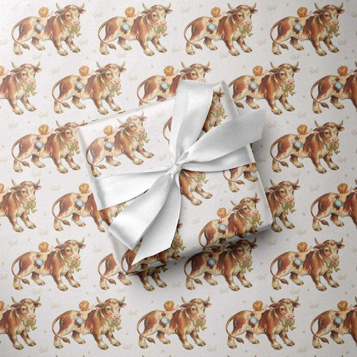 Vintage-inspired cowboy baby boy wrapping paper featuring a repeating 1950s storybook pattern of a baby boy in blue bloomers climbing onto a gentle farm bull on a warm ivory background.