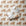 Vintage-inspired cowboy baby boy wrapping paper featuring a repeating 1950s storybook pattern of a baby boy in blue bloomers climbing onto a gentle farm bull on a warm ivory background.