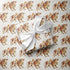 Vintage-inspired cowboy baby boy wrapping paper featuring a repeating 1950s storybook pattern of a baby boy in blue bloomers climbing onto a gentle farm bull on a warm ivory background.
