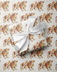 Vintage-inspired cowboy baby boy wrapping paper featuring a repeating 1950s storybook pattern of a baby boy in blue bloomers climbing onto a gentle farm bull on a warm ivory background.