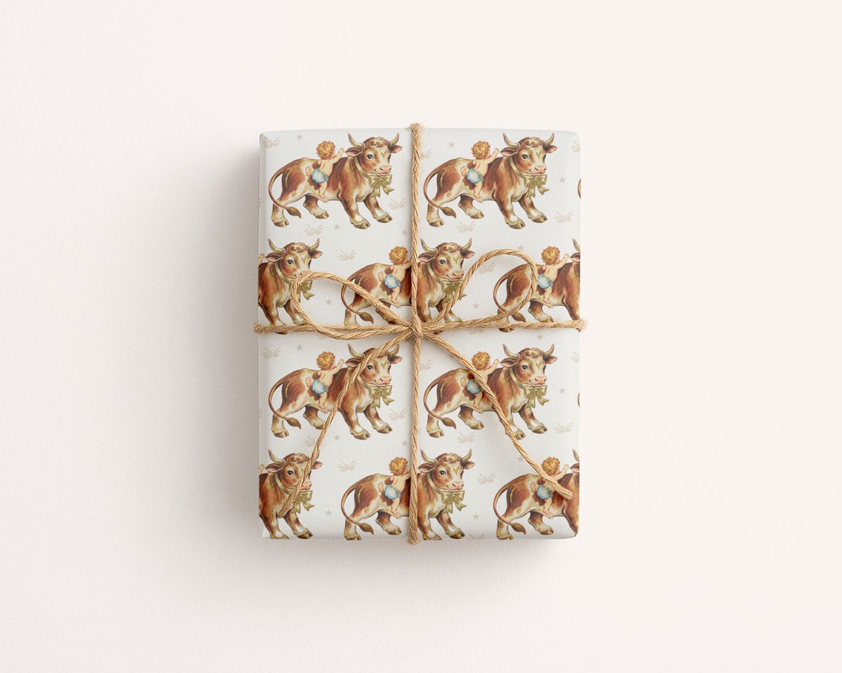 A gift box beautifully wrapped in Harlow Day cowboy wrapping paper, accented with a rustic jute twine string bow for a classic western nursery look.