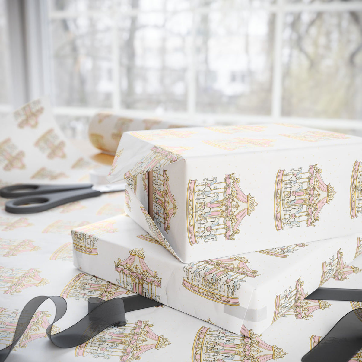White wrapping paper with a repeating pastel carousel print, shown wrapped around gift boxes on a table near scissors and a ribbon, with a softly blurred window background.