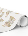 A roll of white wrapping paper featuring a repeating pastel pattern of carousel illustrations, shown on a clean white background.