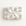 A rectangular gift box wrapped in white paper with a repeating gold carousel pattern, tied with a wide white satin ribbon and bow, photographed from above on a plain white background.