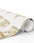 A roll of wrapping paper with a vintage carousel illustration, partially unrolled to show the pattern on a clean white background.