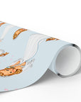 A roll of wrapping paper with a light blue background and a repeating illustration of a retro bride with a veil and bouquet, shown on a clean white background.