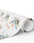 A roll of wrapping paper with a vintage illustration pattern of blue biplanes and a baby girl pilot on a white background.