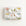 Gift box wrapped in a a decorative paper featuring biplanes in pastels on a light background