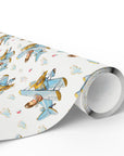 Roll of boy airplane wrapping paper featuring a repeating blue vintage biplane pattern.