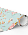 Roll of wrapping paper with a pastel design featuring swans, babies and umbrellas.