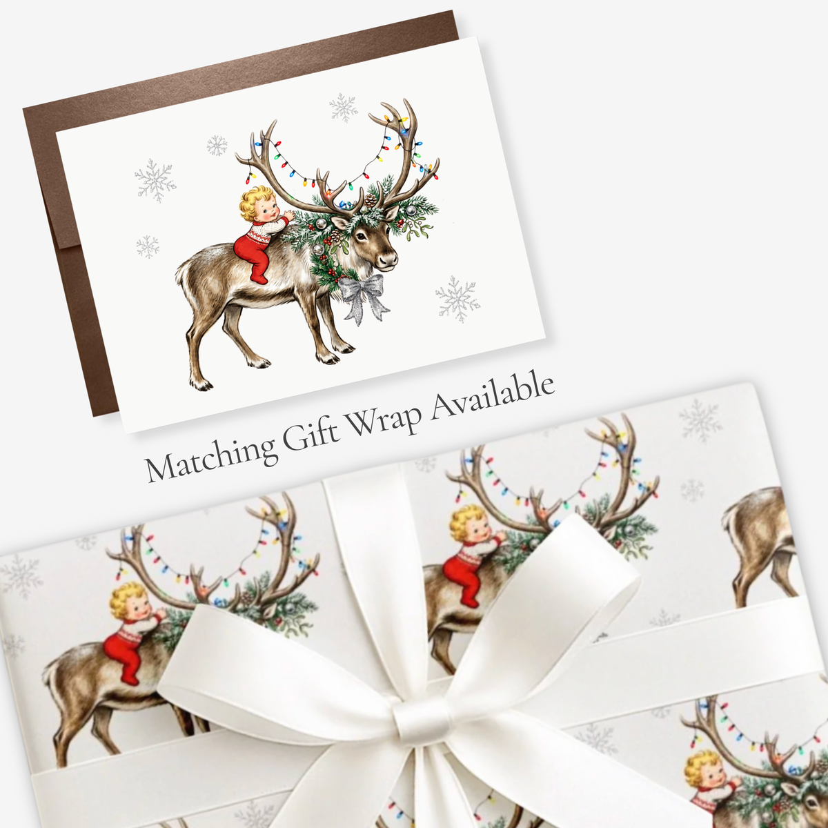 Vintage-style baby's first Christmas card with a baby hugging a reindeer and matching reindeer gift wrap, tied with white satin ribbon