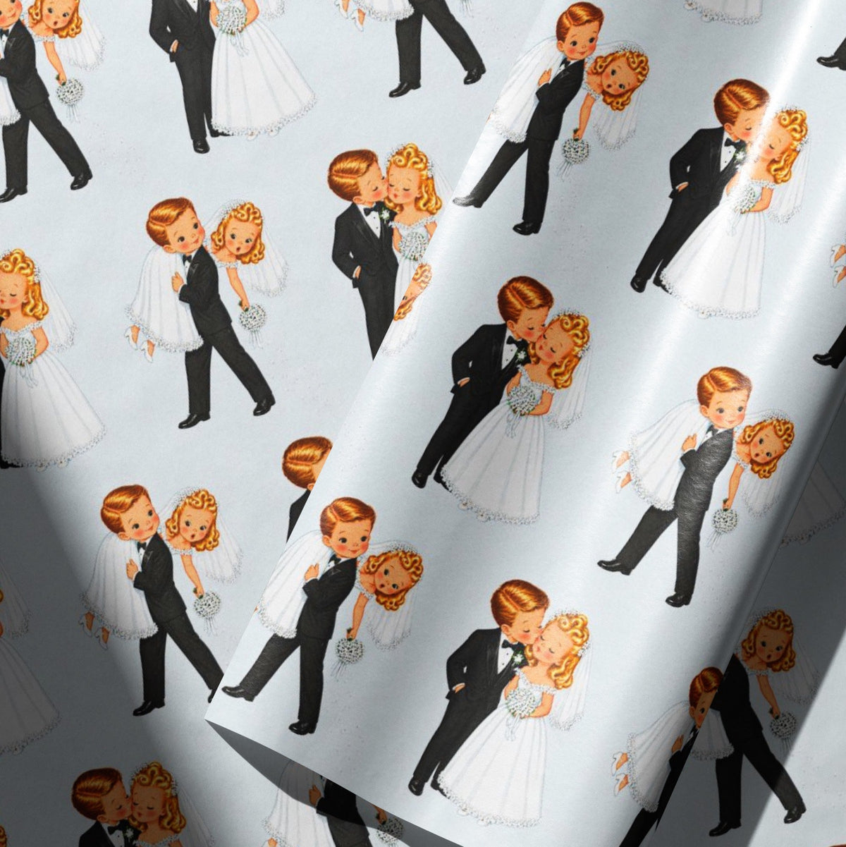 Detailed view of retro wedding gift wrap with a blonde bride in a white gown and a groom in a black tuxedo celebrating their marriage.