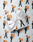 Vintage bride and groom wrapping paper featuring a playful newlywed couple kissing on a pale blue background.