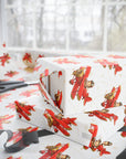 Gift boxes wrapped in paper featuring a little boy flying a red biplane over a delicate aviation navigation map on an ivory background, displayed with an open roll of matching wrapping paper, dark ribbon, and scissors.