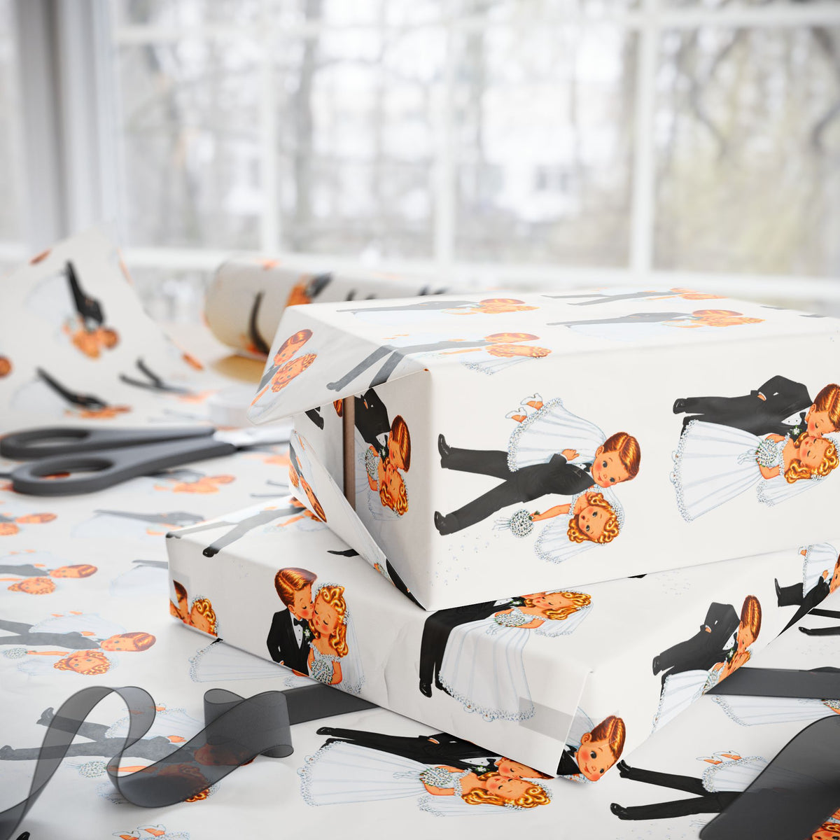 Funny white wrapping paper with a repeating illustration of a bride and groom, shown wrapped around gift boxes on a table with scissors and ribbon near a bright window.