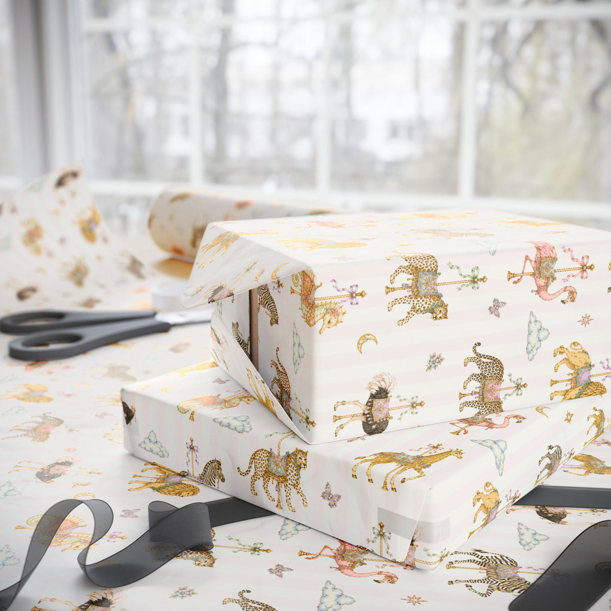 Stack of gifts wrapped in Carousel Menagerie wrapping paper featuring whimsical carousel animals on soft pink stripes, shown with matching gift wrap and ribbon.