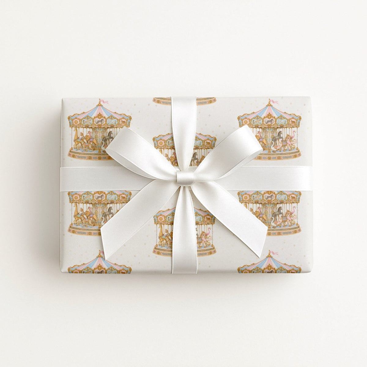 Pink and blue Parisian carousel wrapping paper roll with vintage style merry go round animals and gold scrollwork.