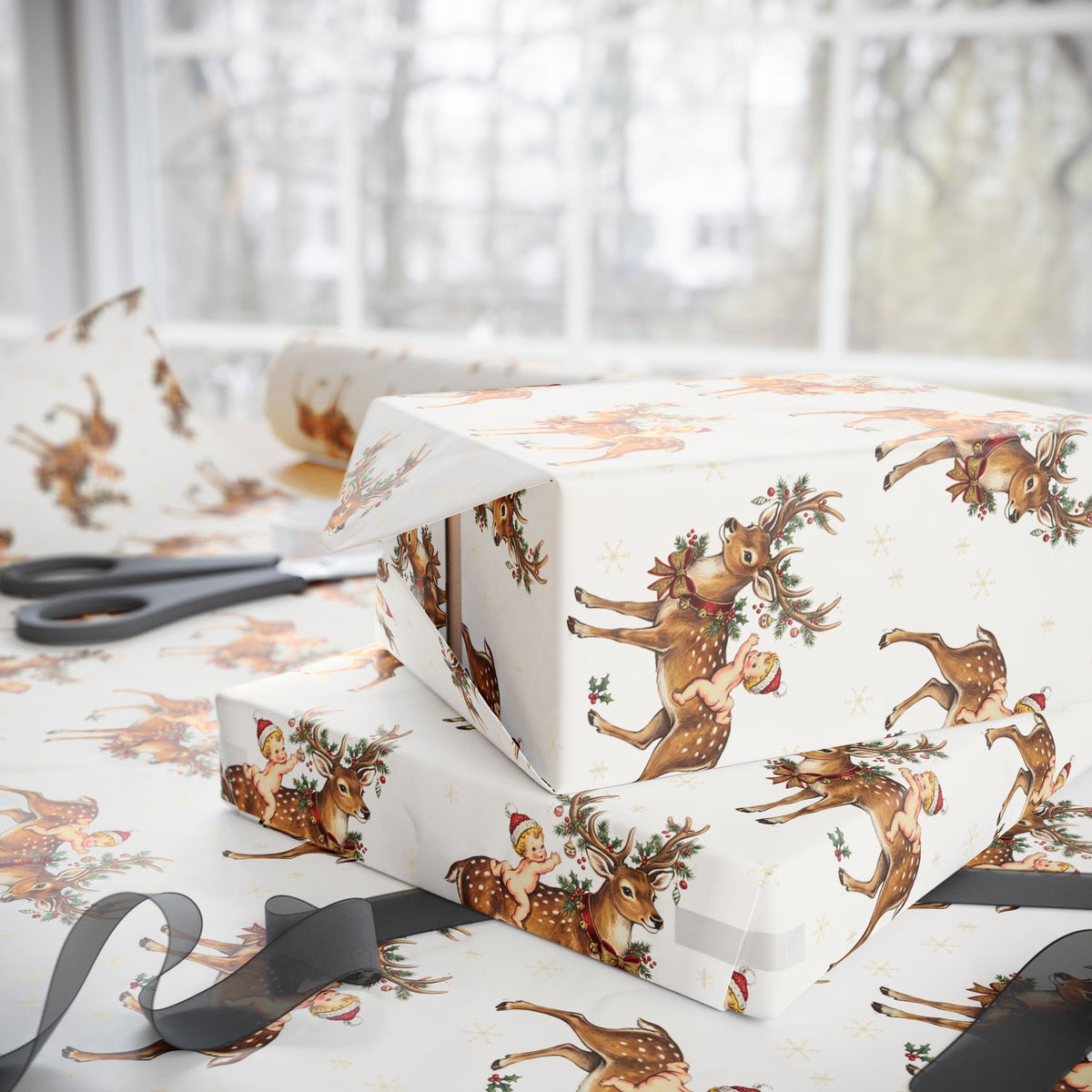 Christmas baby shower wrapping paper with baby riding a reindeer
shown wrapped around gift boxes on a table with scissors and ribbon nearby.