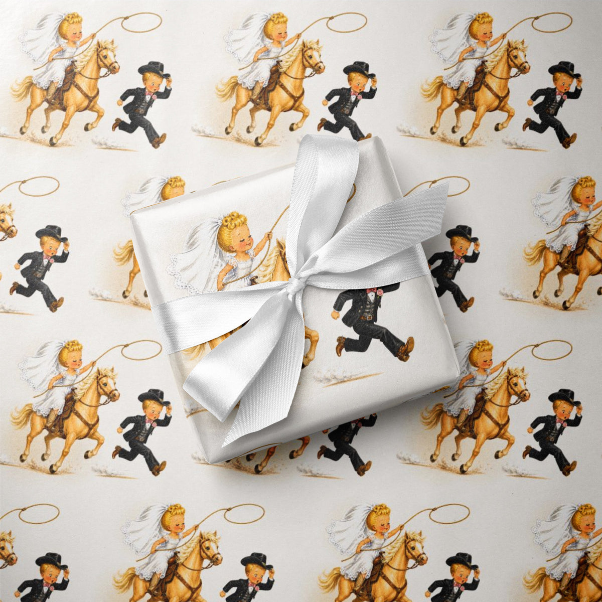 Illustrated cowboy wedding gift wrap pattern: a bride in a lace veil rides a golden horse and swings a lasso as her groom dashes ahead holding his hat.