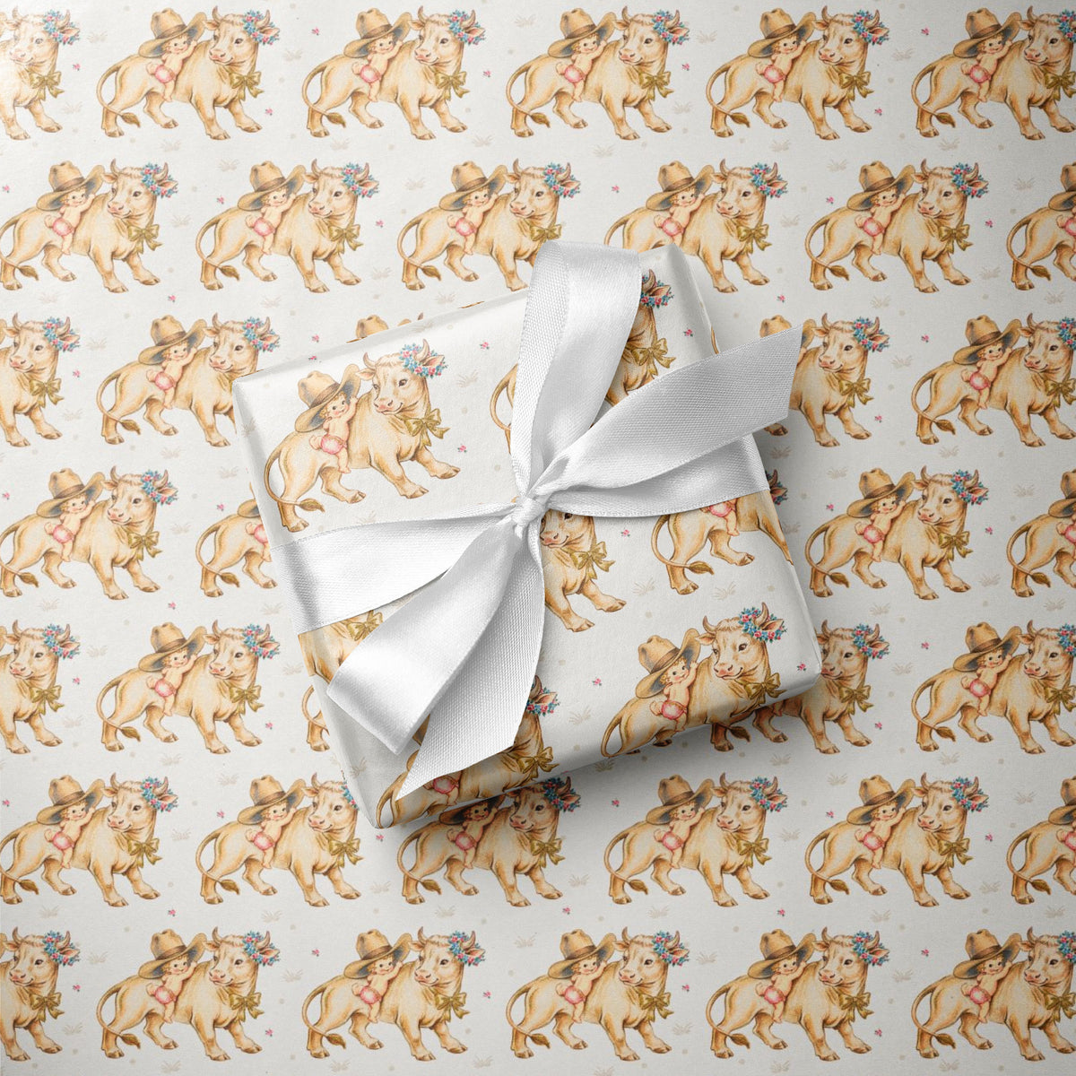 Gift wrapped in paper with calf and baby pattern and wrapped in a white ribbon.