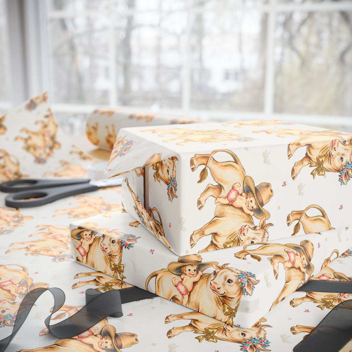 Gift boxes wrapped in vintage-style wrapping paper with babies and cows, on a light background.