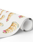 Roll of elegant wedding cake wrapping paper with tiered cakes in warm cream tones and pink roses on a soft ivory background