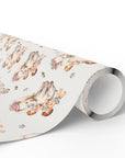 A roll of wrapping paper with a vintage-style watercolor illustration of babies climbing on elephants shown partially unrolled.