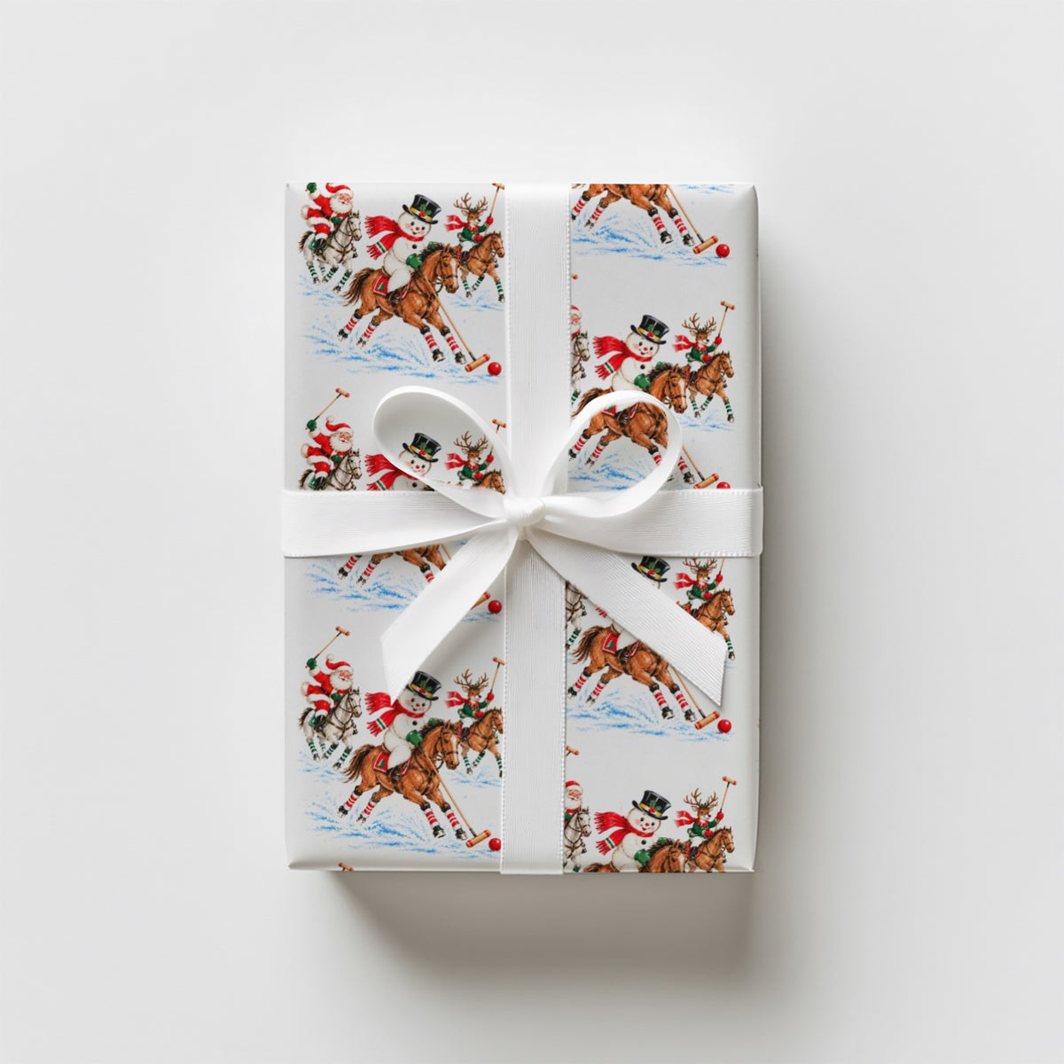 Upright gift wrapped in vintage-style polo match Christmas wrapping paper with a white satin ribbon and bow